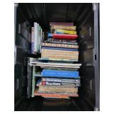 Various Hardcover and Paperback Books in Black Bin