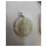 Carved Pendant Depicting Deity Design with Silver