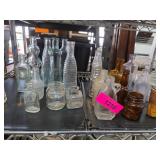 Vintage Glass Bottles and Jars on Metal Shelves