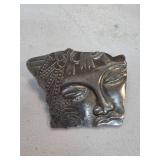 Face-Shaped Metal Brooch with Intricate Patterns