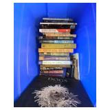 Hardcover and Paperback Books in a Storage Bin