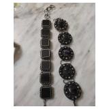 Two Silver-Toned Bracelets Featuring Black and Pur
