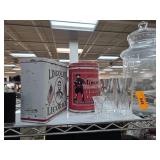 Two Decorative Tin Containers With Glassware