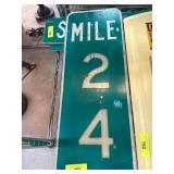 Green Metal Road Sign with ï¿½Smile 24ï¿½