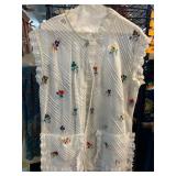 White Sleeveless Button-Up Garment With Embroidery