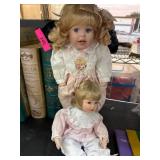 Two Porcelain Dolls in Detailed Clothing
