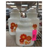 Three White Glass Canisters with Floral Design