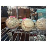Three Baseballs in Display Cases