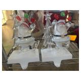 Two Light-Up Santa Figurines