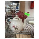 Two Ceramic Teapots with Floral and Solid Designs