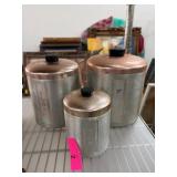 Three Metal Canisters with Copper Lids