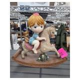 Figurine of Child on Rocking Horse
