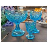 Three Blue Glass Pedestal Vessels