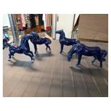 Four Glossy Blue Ceramic Horse Figurines