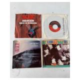 Four 7-Inch Vinyl Singles with Sleeves