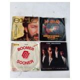 Four 7-Inch Vinyl Records with Covers