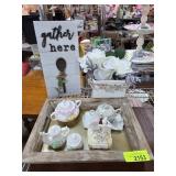 Decorative Tea Set, Floral Display, and Sign