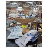 Decorative Basket with Ceramic Teapot and Linens