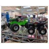 Two Monster Truck Toys Featuring Graphic Designs