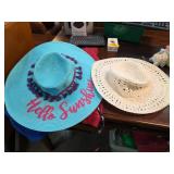 Two Straw Hats With Unique Designs