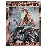 Metal Sign Featuring Motorcyclist and Quote