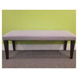 Gray Upholstered Bench With Dark Wood Legs