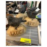 Three Bird Figurines On Engraved Rocks