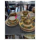 Gilded Porcelain Dinnerware Set With Cherub Motif
