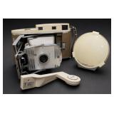 Vintage Polaroid Land Camera and White Accessory