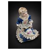 Seated Child Figurine With Open Book