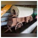 Covered pioneer wagon, 15’ long, 3’3” wide w/canvas top, 48” wooden spoke rear wheels & 45” wooden spoke front wheels, double horse hitch, paraded all over Michigan