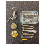 Ford Button, Fairbanks Morse Tape Measure, and small wrenches.