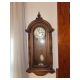 Wood Tone Display Shelf with Four Tiers, Crutches, Wall Clock, and More