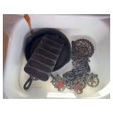 Cast Iron Cookware Lot Including Frying Pan, Cornbread Mold, and Decorative Trivet