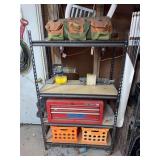 Metal shelf with tool box and everything else on it