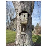 Three wood large bird houses with the tallest being 30 inches