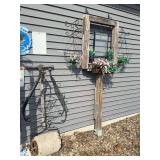 Antique yard roller, horse bridal, and faux flowers