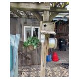 Two bird houses and a planter