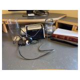 Assorted Household Items Including Emerson Alarm Clock, Holy Bible, and Ozark Trail Lantern