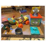 Assorted Toys Including Fisher-Price, Musical Toy, Tin Spinning Top, and More