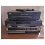 Lot of Three Home Media Players: JVC VCR, Sylvania DVD Player, and SR 1000 Series VCR with Remotes