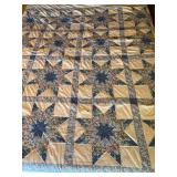 Lone Star Pattern Quilt with Floral and Solid Blue Fabric