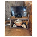 Element Flat Screen Television on Metal and Wood Stand with Seashell Collection