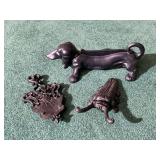 Cast Iron Decorative Lot: Dachshund Boot Scraper, Beetle Boot Jack, and Ornate Trivet