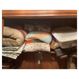 Quilts, blankets and storage bags in closet