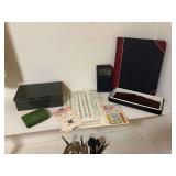 Collection of Office and First Aid Supplies including Metal First Aid Kit, Ledger, and Reference Guides