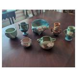 Collection of Seven Roseville Pottery Pieces with Floral Relief Designs