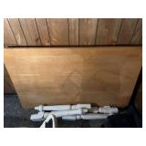 Disassembled Wooden Dining Table with Natural Finish Top and White Turned Legs
