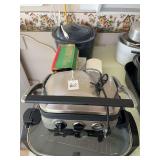 Kitchen Appliance and Tool Lot including Cuisinart Griddler, Oster Electric Grill, Enamel Roaster, Food Grinder, and Slicers