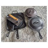 Cast Iron Cookware Assortment including Griddle Skillets Lids and Press